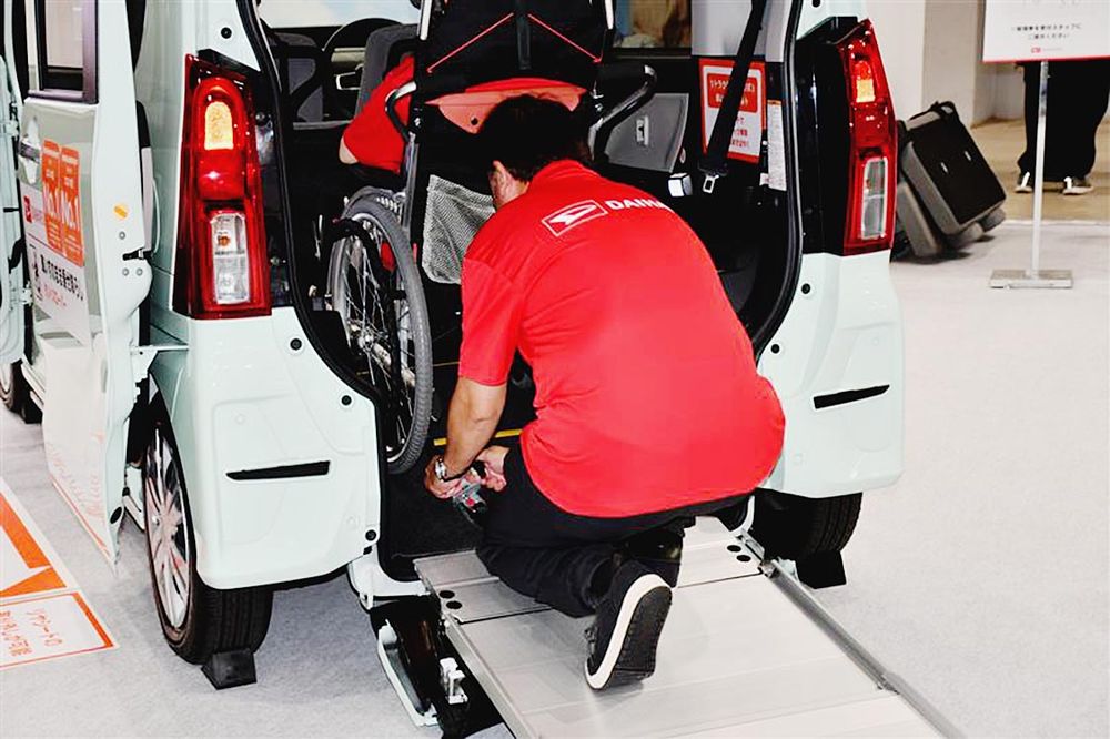 車いすの固定作業は前かがみで負担がかかる