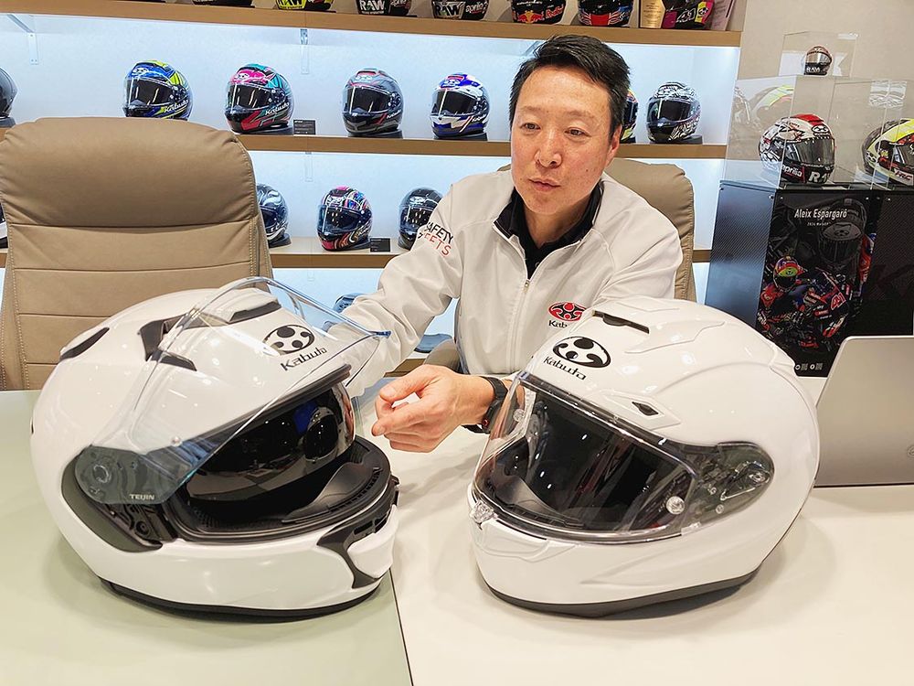 オージーケーカブトのヘルメットの進化について解説する柿山課長。「空気の流れを制御する技術開発の歴史です」
