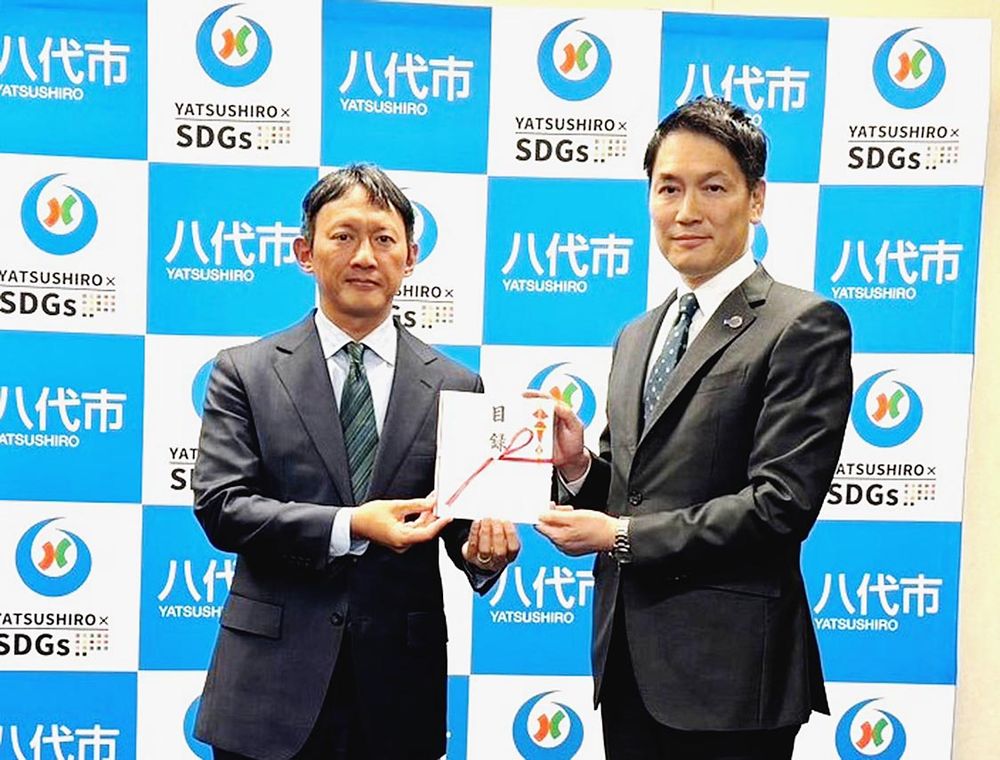 八代市の小野泰輔市長（左）とタウの熊野真吾専務